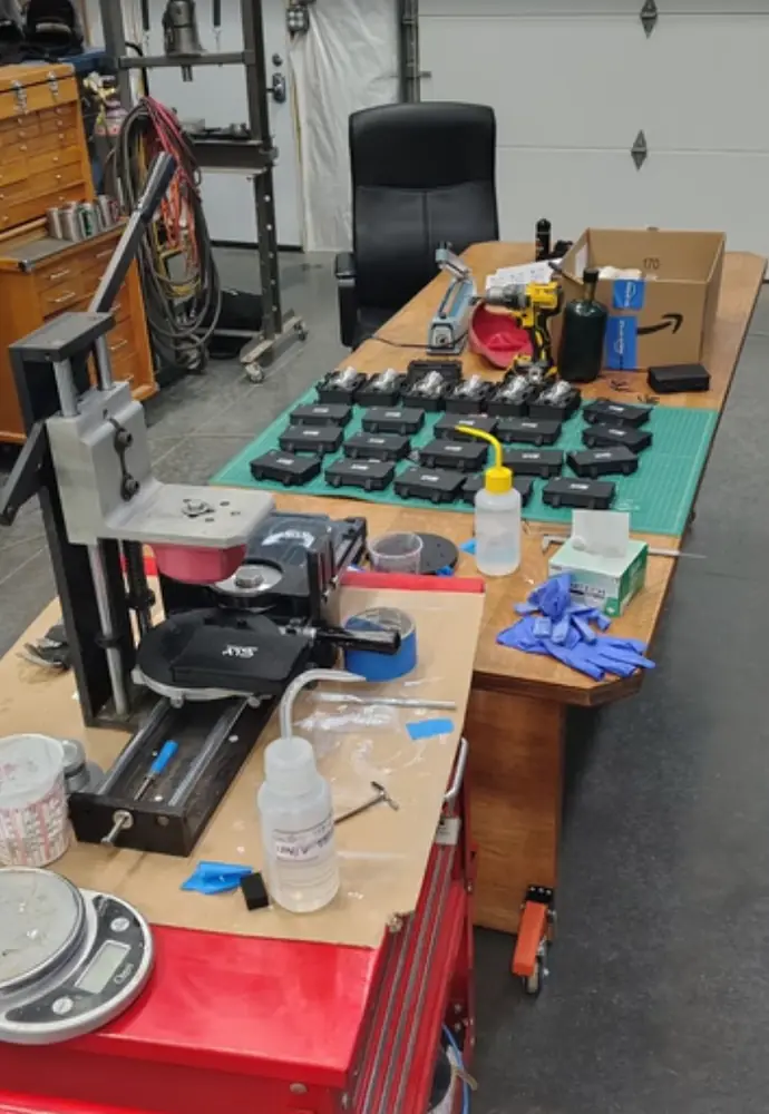 Infinity Chalice production run with rows of black cases on the shop table