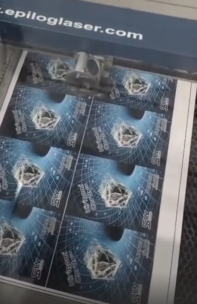 Epilog laser cutting a sheet of printed Kirigami Cards tuck boxes