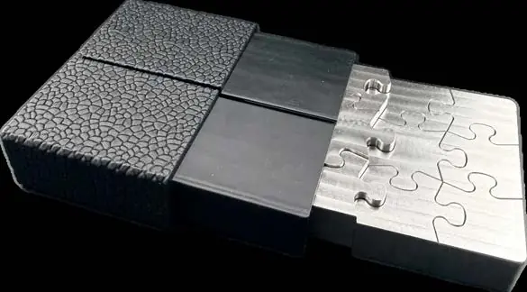 Assembled NEUTRINO stainless steel block sliding out of its black textured case